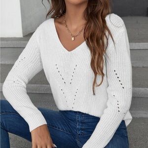 White long sleeved sweater with bow ties on the back